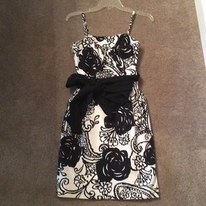 White dress with black flower pattern & black belt